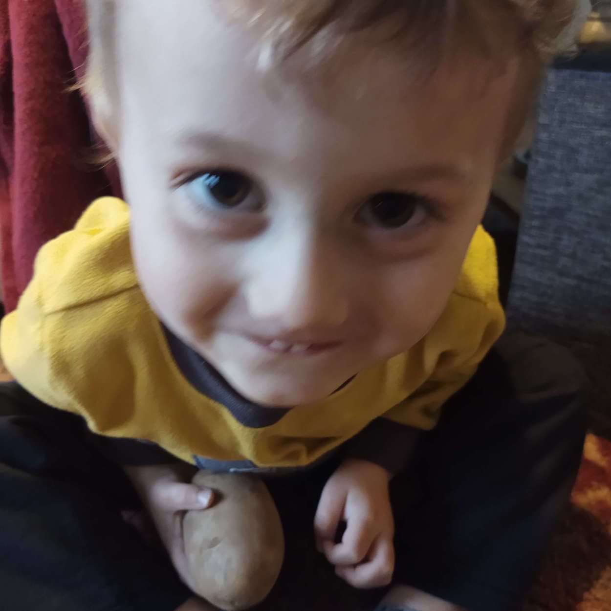 boy tossing a potato